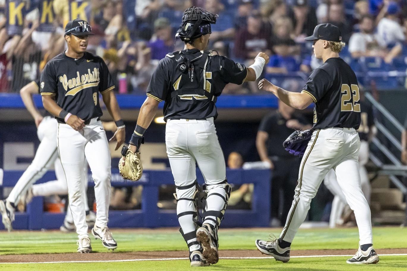 Vanderbilt players Alan Espinal (middle) and JD Thompson (right) fist bump